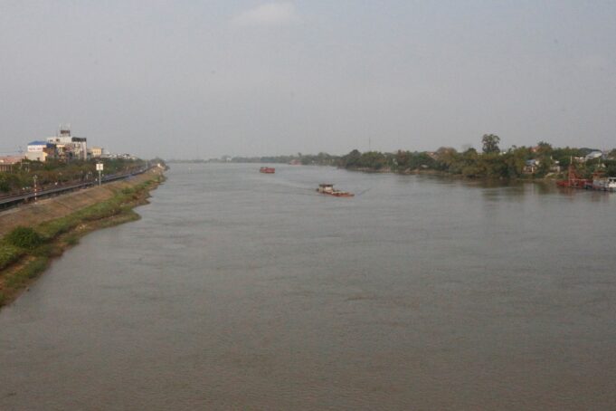 Boats travel up and down the Red River, Vietnam, near the site of the trash trap